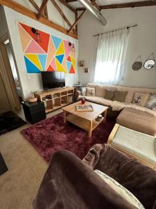 a living room with a couch and a table at 7ο_seahome in Alexandroupoli