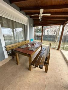 a wooden table and bench on a screened in porch at 7ο_seahome in Alexandroupoli