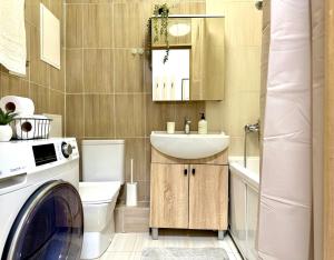 a bathroom with a washing machine and a sink at Студия МЕРЕНГА в центре Алматы in Almaty +17 photos