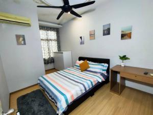 a bedroom with a bed and a ceiling fan at 678 homestay 4 room 5 minutes to tower in Teluk Intan