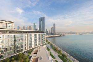 a view of a city with a body of water at Upgraded 2BR Plus Maid's Room with Sea View - Livbnb Bluewaters Suites in Dubai