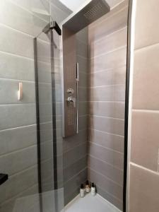 a shower with a glass door in a bathroom at Studio neuf - parking - 3 Epis proche Turckheim in Turckheim