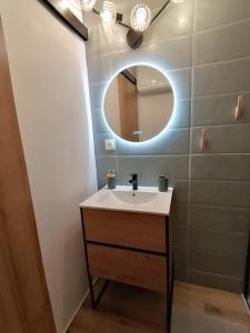 a bathroom with a sink and a mirror at Studio neuf - parking - 3 Epis proche Turckheim in Turckheim