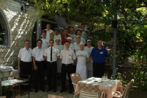 a group of men are posing for a picture at Apartments and Rooms Drago in Sveti Stefan