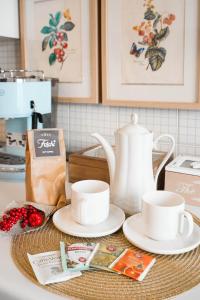 a kitchen counter with two cups and a tea kettle at B&b Piazzetta in Fermo