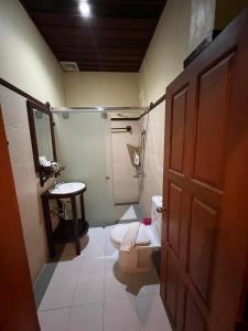 a small bathroom with a toilet and a sink at Luang Prabang Champa Villa in Luang Prabang