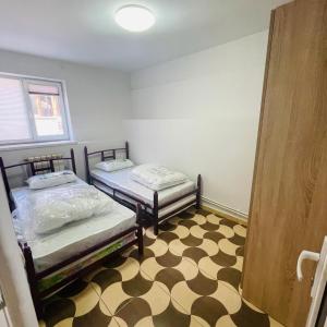 two beds in a room with a checkered floor at Аренда Квартиры в Ереване (Зейтун) - Apartment Rent in Yerevan (Zeytun) in Yerevan