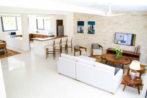 a living room with a white couch and a table at ZANA DIANI VILLAS in Ukunda