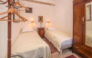 1 dormitorio con 2 camas y vestidor con 2 lámparas en Pet Friendly Home In Castel Vittorio With Kitchen, en Castel Vittorio