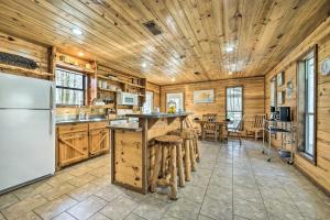 a kitchen with wooden walls and a wooden ceiling at Broken Bow Getaway Hot Tub, Grill and Fire Pit in Broken Bow