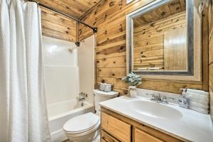 a bathroom with a toilet and a sink and a tub at Broken Bow Getaway Hot Tub, Grill and Fire Pit in Broken Bow +28 photos