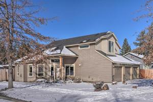 a house with snow on the ground in front of it at Family-Friendly Oregon Vacation Home with Yard in Bend