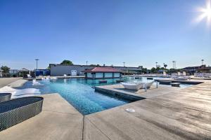 a swimming pool with chairs and a building at Ozarks Vacation Rental Condo with Lake View! in Lake Ozark