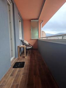 a room with a balcony with a bench and a window at Stan na dan Iv in Lukavica
