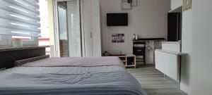 Postel nebo postele na pokoji v ubytování Nataly Apartment