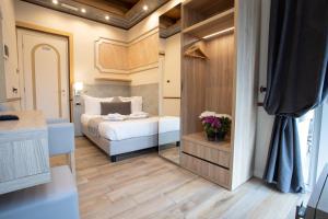 a small bedroom with a bed and a mirror at Antica Piacenza in Piacenza