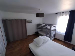 a bedroom with a bed and a desk and a window at Les Hirondelles in Berck-sur-Mer