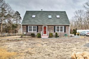 a house with a red door in a yard at Cozy Edgartown Vacation Rental Near Beach! in Edgartown