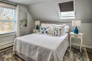 a bedroom with a bed with blue and white pillows at Cozy Edgartown Vacation Rental Near Beach! in Edgartown