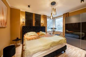 a bedroom with a large bed and a window at Fewo Elegance in Binz