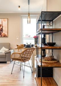a kitchen and living room with a table and chairs at Fewo Elegance in Binz