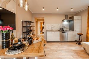 a kitchen with a wooden table in a room at Fewo Elegance in Binz