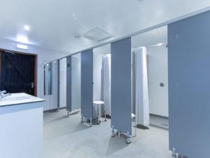 a bathroom with a row of sinks and mirrors at Fairwood Lakes - Shepherd's Hut with Hot Tub in North Bradley