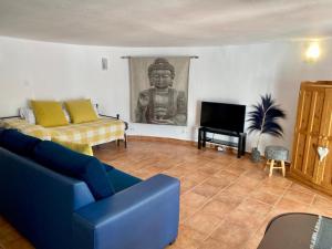 'Coll de Rates' Beautiful 1-Bed Apartment في ألكالالي: غرفة معيشة مع أريكة وتمثال