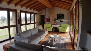 a living room with a couch and two chairs at Ostello Molino Di Basso in Roccafranca