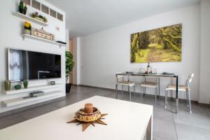 a living room with a table and a tv at Mare Home - Beach & City in Las Palmas de Gran Canaria
