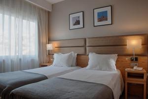 Un pat sau paturi într-o cameră la Hotel Oslo