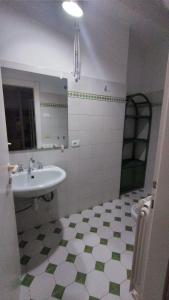 a bathroom with a sink and a toilet and a mirror at Monolocale La Darsena in Portoferraio