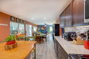 a kitchen with orange walls and a dining room at Payson Vacation Rental with Private Patio! in Payson