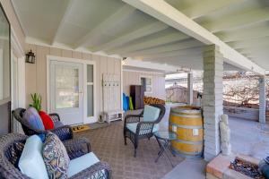 a living room with chairs and a table and a barrel at Payson Vacation Rental with Private Patio! in Payson