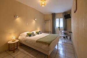 Postel nebo postele na pokoji v ubytování L'Aptois Hôtel