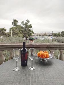 a table with a bottle of wine and two glasses at Apartment Dario in Zadar