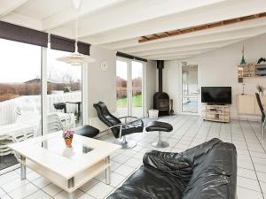 een woonkamer met een bank en een tafel bij 10 person holiday home in Ebeltoft in Ebeltoft