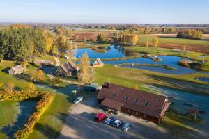 an aerial view of a house and a lake at Sodyba Vieversynė in Duokiškis