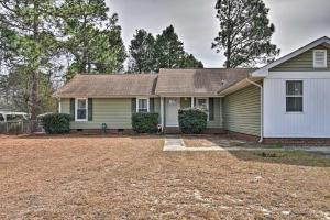 a green house with a yard at Fayetteville Vacation Rental with Sunroom and Yard! in Fort Bragg