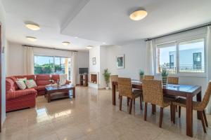 a living room with a table and chairs and a couch at Apart-rent Villa Pani 0145 in Empuriabrava
