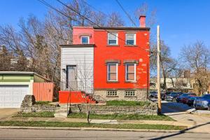 a red house on the side of a street at Cincinnati Vacation Rental 6 Mi to Downtown! in Cincinnati