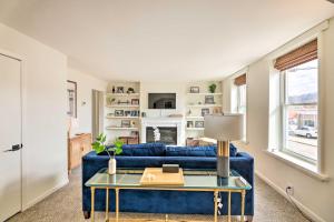 a living room with a blue couch and a table at Cincinnati Vacation Rental 6 Mi to Downtown! in Cincinnati