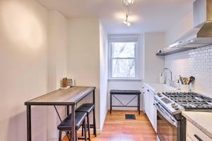a kitchen with a wooden table and a counter top at Cincinnati Vacation Rental 6 Mi to Downtown! in Cincinnati +19 photos