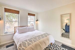 a white bedroom with a bed and two windows at Cincinnati Vacation Rental 6 Mi to Downtown! in Cincinnati