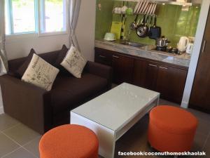 a living room with a couch and a table at Coconut Homes Khao Lak in Khao Lak