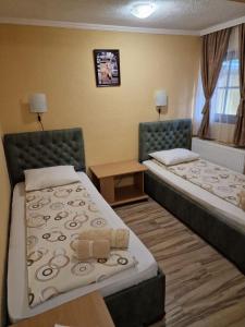 a hotel room with two beds and a window at Etno kuca sa konacistem GOCKO in Vrnjačka Banja
