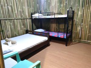 two bunk beds in a room with a fence at Bella's Beach Resort Apartment 8 in Bauang