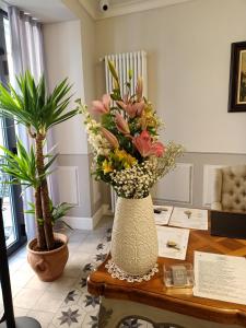 un vase rempli de fleurs assis sur une table dans l'établissement Antico Borgo B&B, à Cannobio