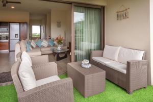 a living room with a couch and chairs and a table at SLEEP IN MAURITIUS in Grand Baie