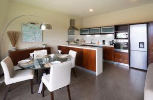 a kitchen and dining room with a table and chairs at SLEEP IN MAURITIUS in Grand Baie